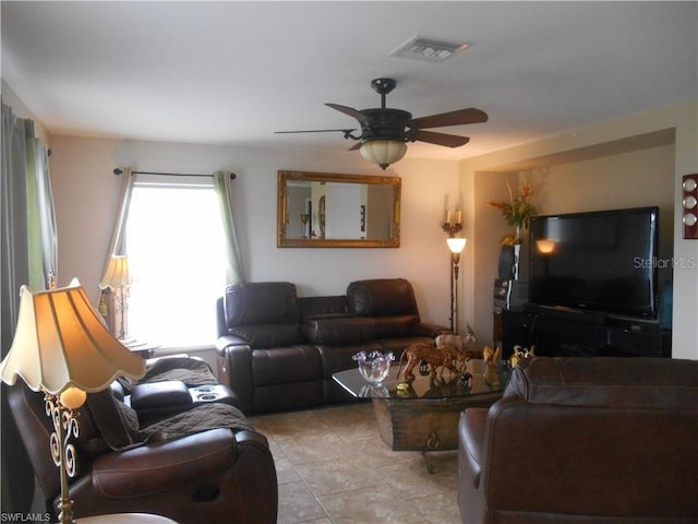 living room featuring ceiling fan and light tile floors