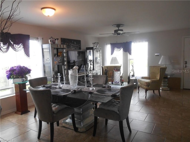 tiled dining space with ceiling fan