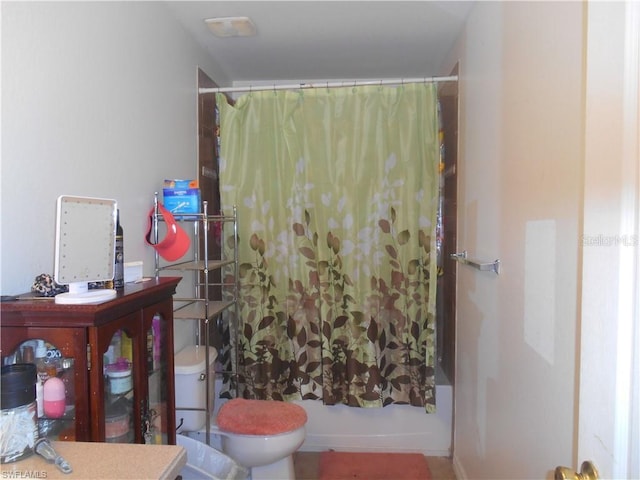 full bathroom with shower / bath combination with curtain, vanity, and toilet