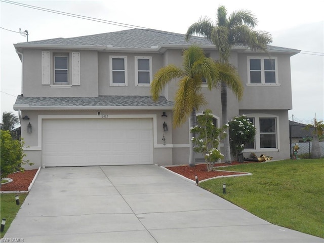 view of front facade with a garage and a front lawn