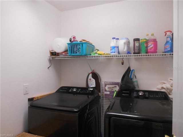 laundry room with washing machine and clothes dryer