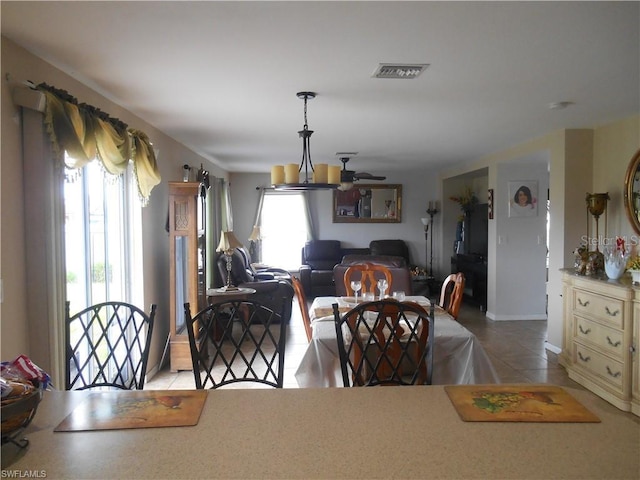 tiled dining area with ceiling fan