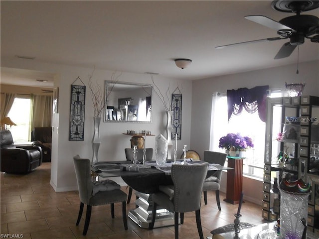 dining area featuring tile floors, a wealth of natural light, and ceiling fan