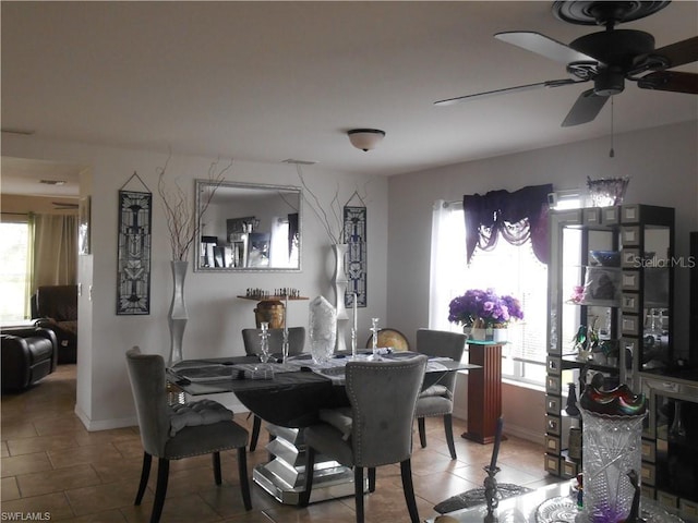 tiled dining space with ceiling fan