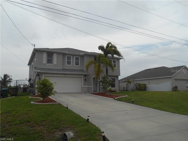 view of front of property featuring a front yard and a garage