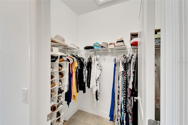 walk in closet with light tile patterned floors