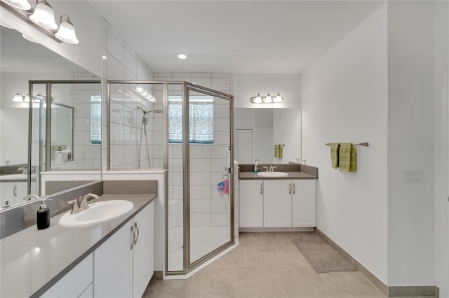 bathroom featuring tile patterned floors, vanity, and a shower with shower door