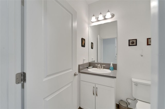 bathroom featuring vanity and toilet