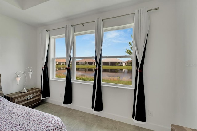 bedroom featuring a water view