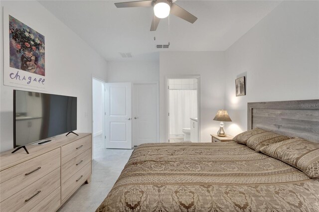 bedroom with ensuite bath and ceiling fan