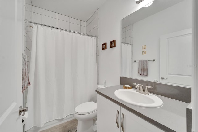 full bathroom with shower / tub combo with curtain, vanity, and toilet