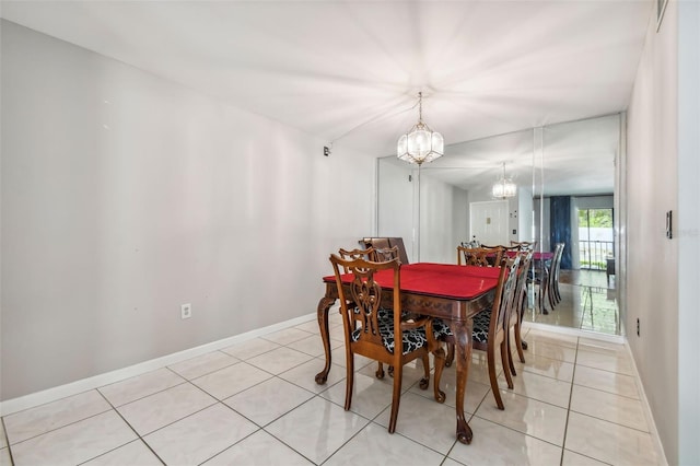 tiled dining space featuring a chandelier