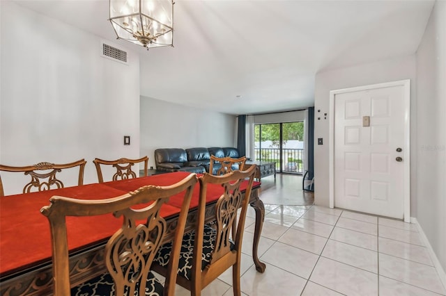 dining space featuring a notable chandelier and light tile patterned floors