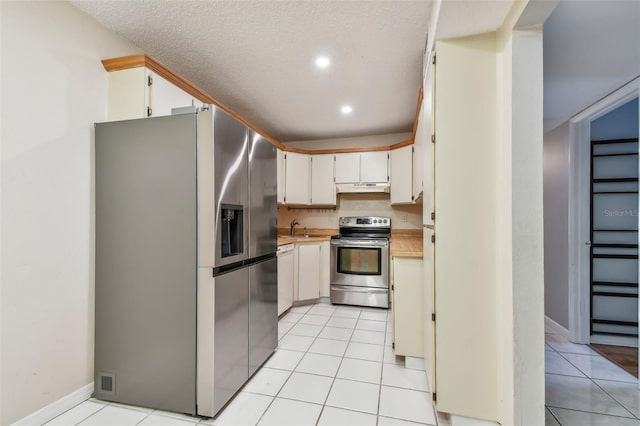 kitchen featuring appliances with stainless steel finishes, light tile patterned floors, and sink