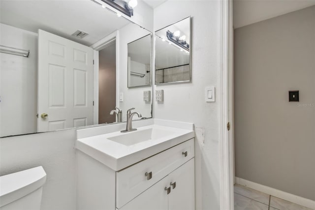 half bathroom with visible vents, baseboards, toilet, tile patterned flooring, and vanity