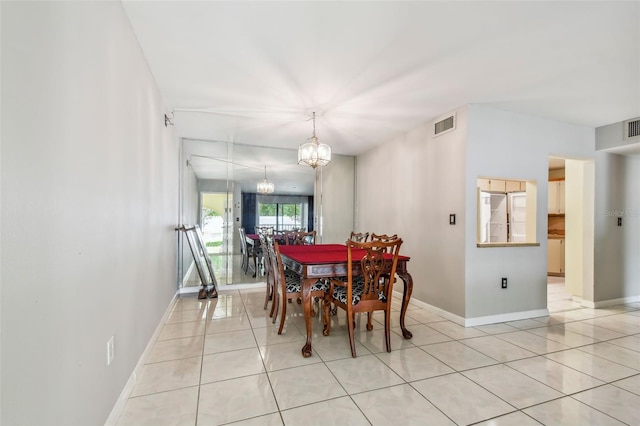 dining room featuring a notable chandelier and light tile patterned floors