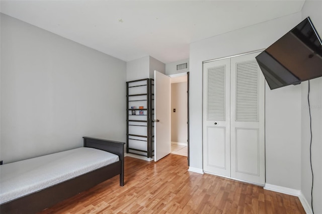 bedroom featuring light wood-type flooring and a closet