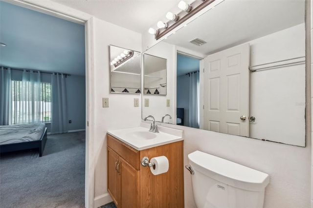 bathroom featuring visible vents, vanity, and toilet