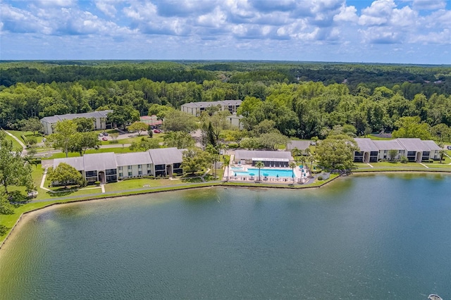 drone / aerial view with a water view and a wooded view