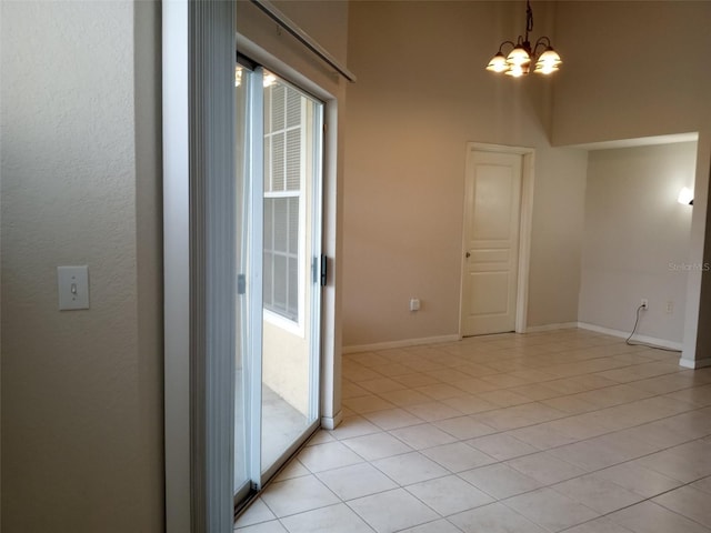 interior space featuring light tile patterned floors and a chandelier