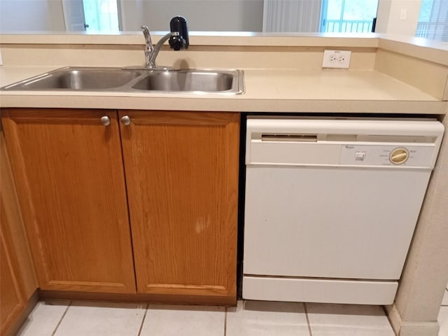 kitchen featuring dishwasher, sink, and light tile patterned floors