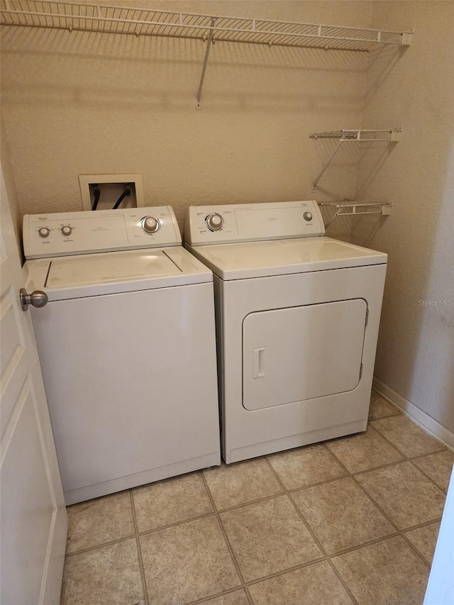 washroom with light tile patterned flooring and separate washer and dryer