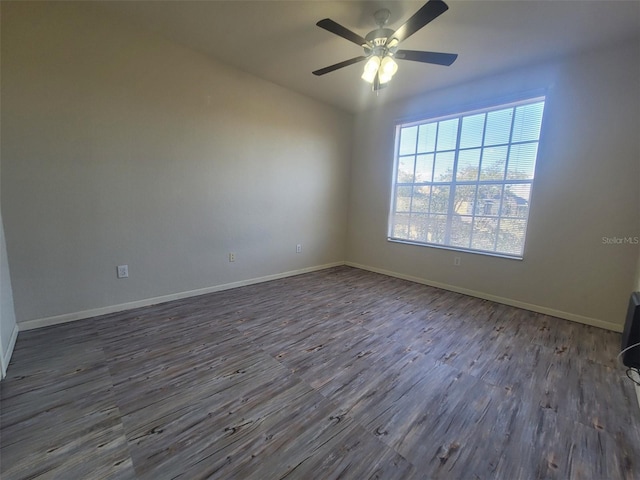 unfurnished room with dark hardwood / wood-style flooring and ceiling fan