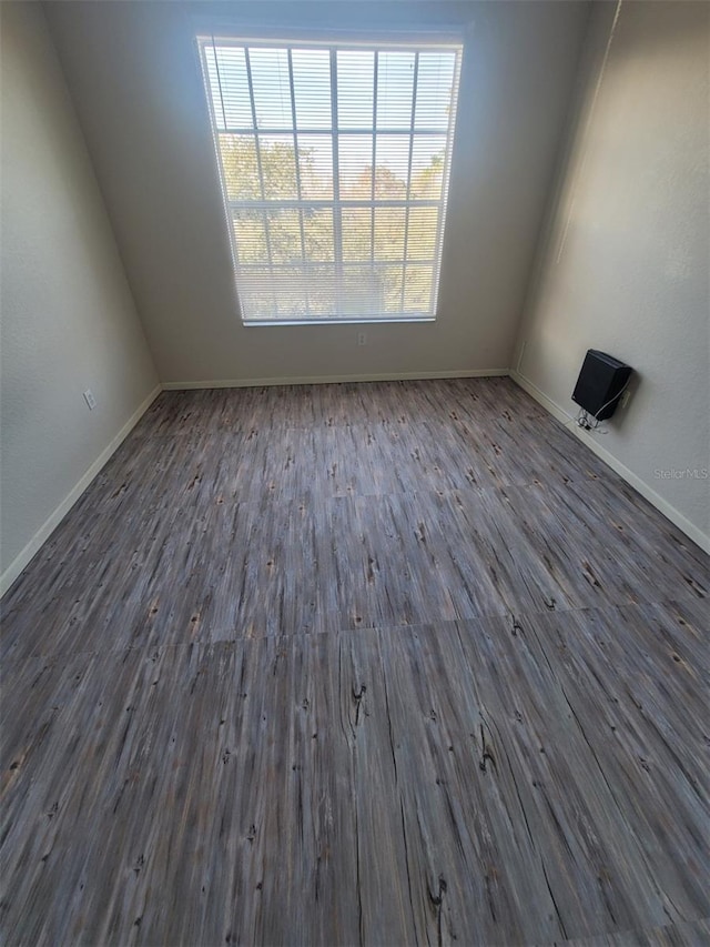 unfurnished room featuring dark hardwood / wood-style flooring