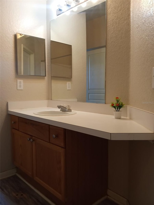 bathroom with vanity and wood-type flooring