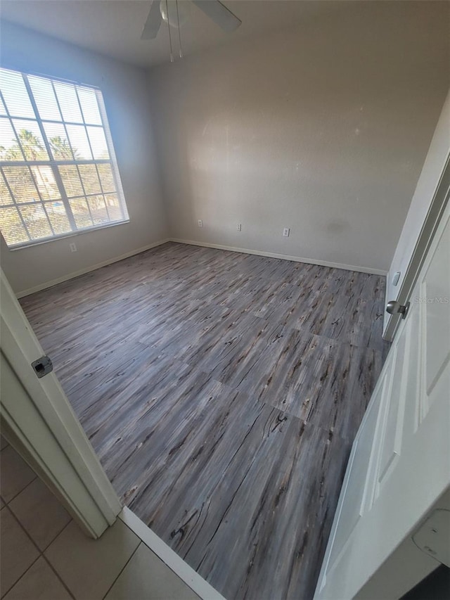 spare room with hardwood / wood-style flooring and ceiling fan