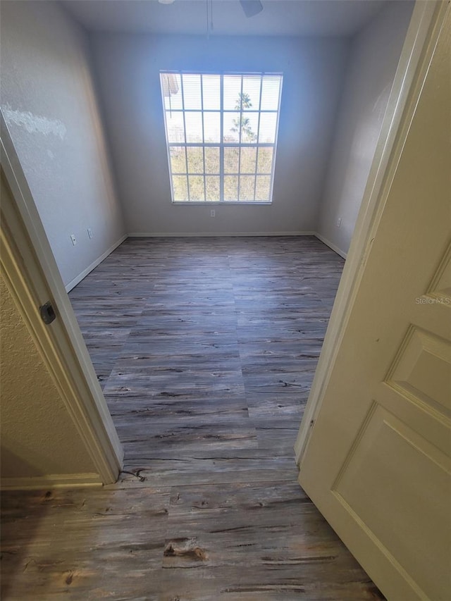 unfurnished room with dark wood-type flooring