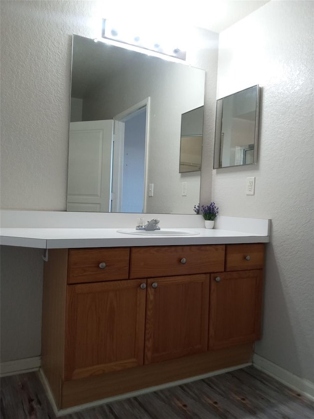 bathroom with wood-type flooring and vanity