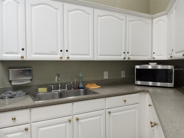 kitchen featuring sink and white cabinets