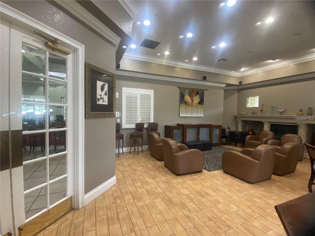 cinema with ornamental molding and light hardwood / wood-style floors