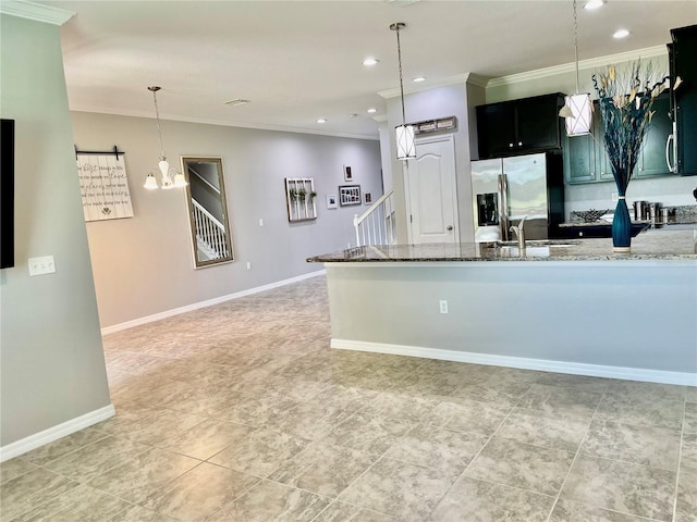 kitchen with crown molding, stainless steel refrigerator with ice dispenser, hanging light fixtures, sink, and light stone counters