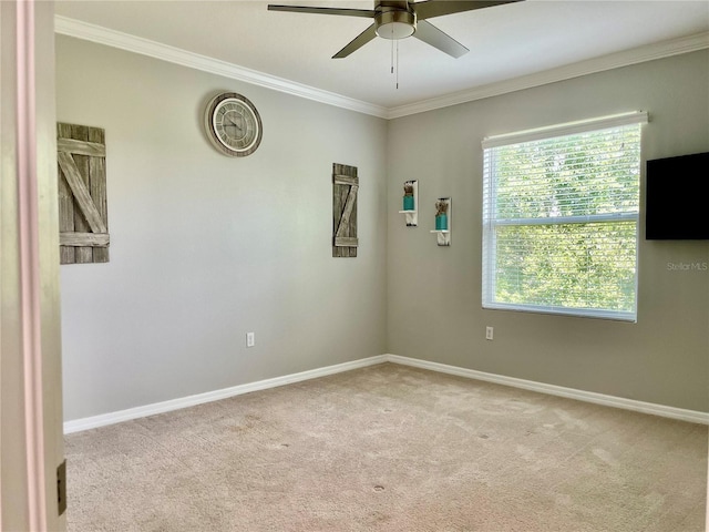 unfurnished room featuring light carpet, crown molding, baseboards, and ceiling fan