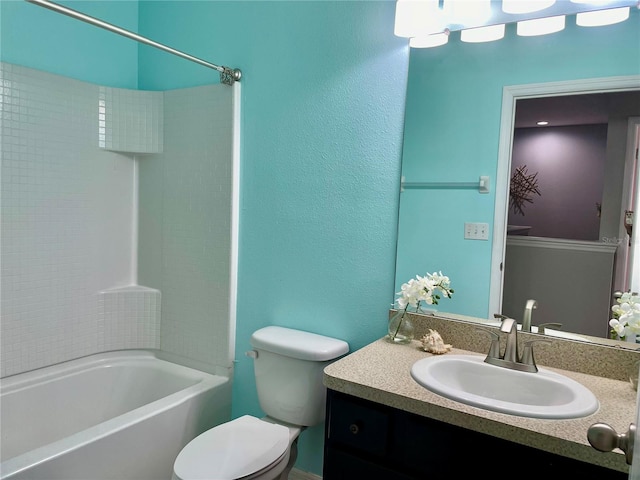 bathroom with bathing tub / shower combination, vanity, and toilet