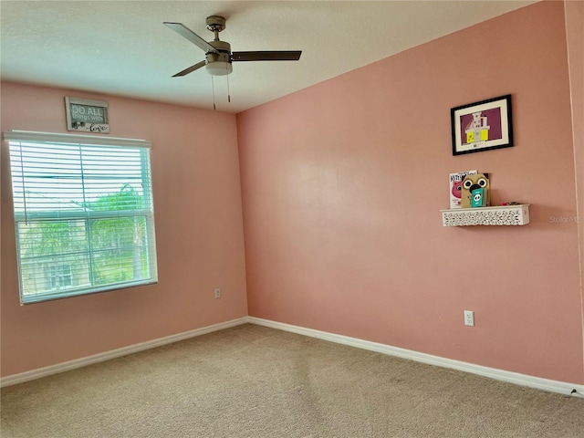 unfurnished room featuring ceiling fan and carpet floors