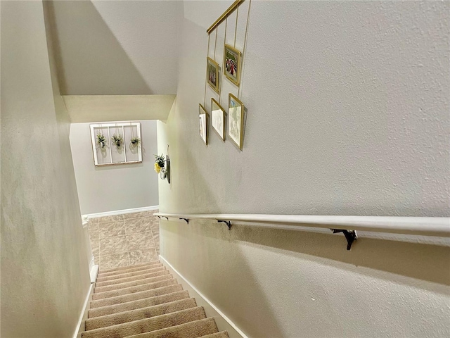 stairway featuring baseboards