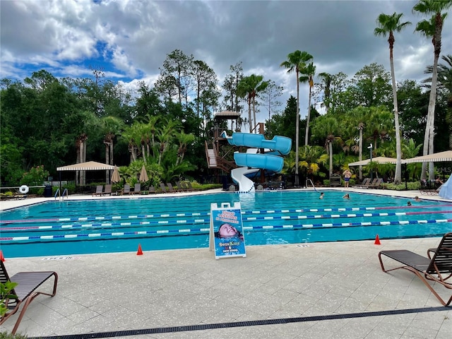 view of pool featuring a patio area and a water slide