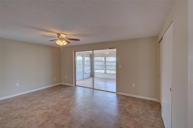 empty room featuring ceiling fan and a textured ceiling