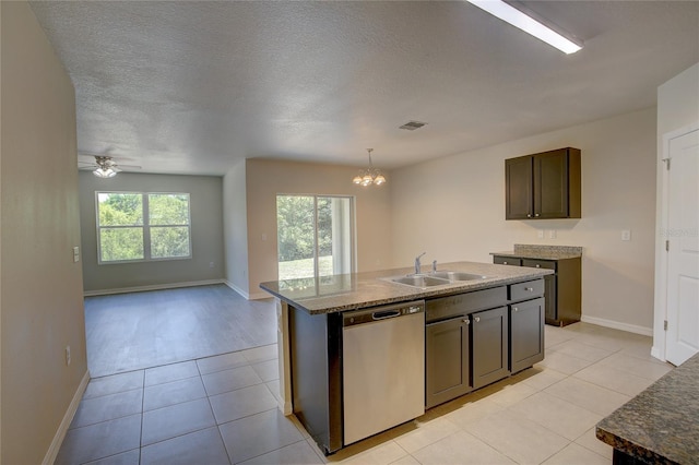 kitchen featuring dishwasher, a center island with sink, sink, light tile patterned floors, and ceiling fan with notable chandelier