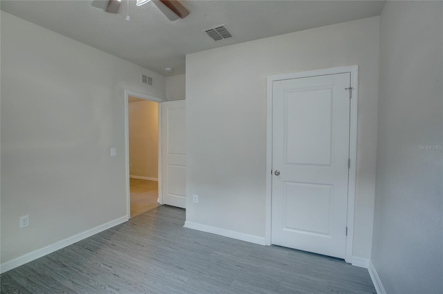 empty room featuring ceiling fan and light wood-type flooring