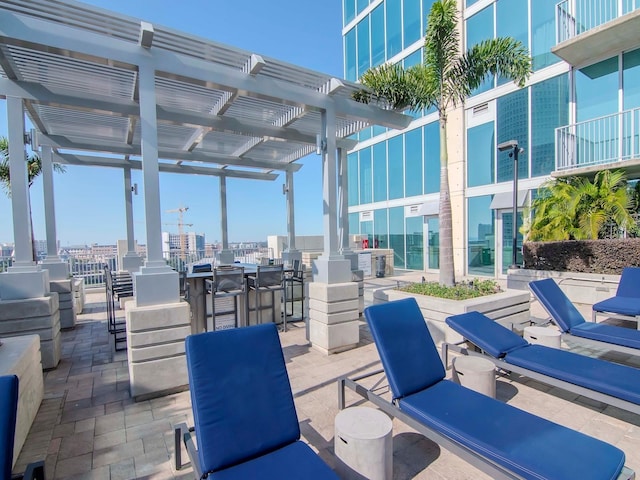 view of patio / terrace featuring exterior bar and a pergola