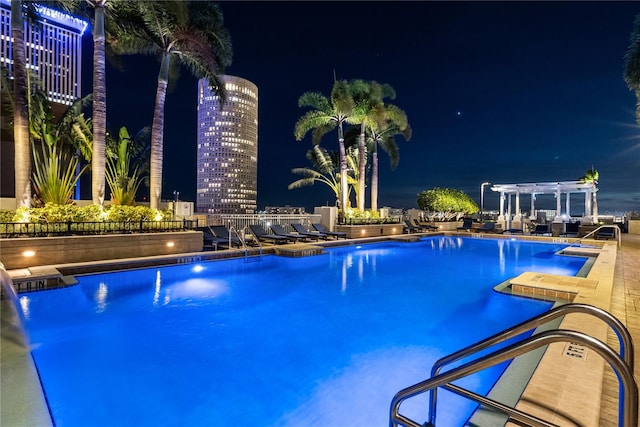 pool at twilight with a pergola