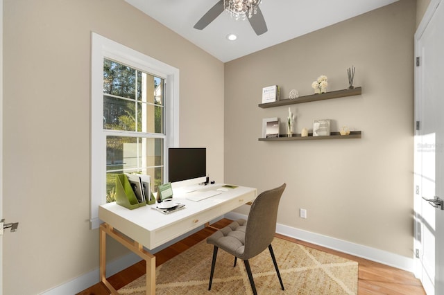 home office with ceiling fan and light hardwood / wood-style flooring