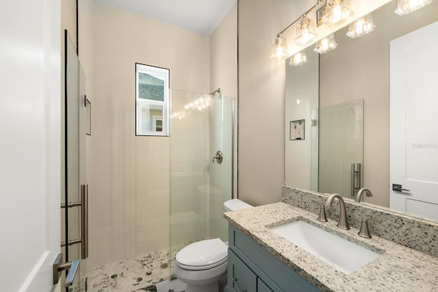 bathroom featuring vanity, toilet, and walk in shower