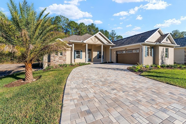 view of front of home with a front yard and a garage