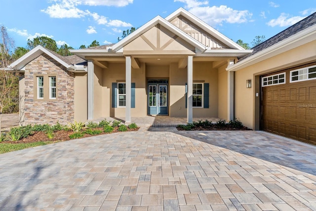 view of front of house featuring covered porch and a garage