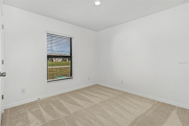 unfurnished room featuring carpet